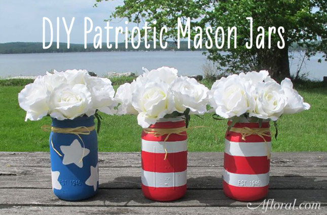 Red and white stripped and blue and white star mason jars filled with white flowers