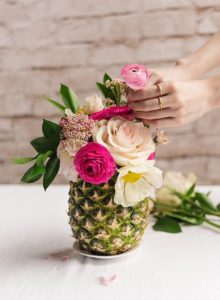 Pineapple with colorful flowers in it