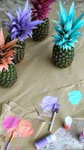 pineapples with different color painted stems